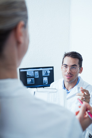 Male and female dentists discussing reportsの写真素材
