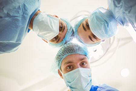 Young surgeons looking down at camera  at the university