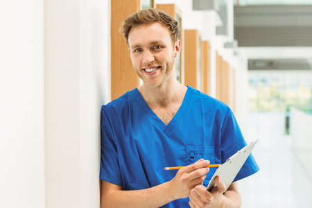 Medical student smiling at camera in hallway at the university