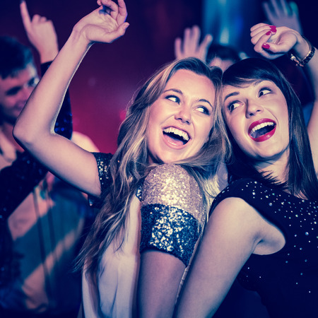 Happy friends having fun together at the nightclubの写真素材