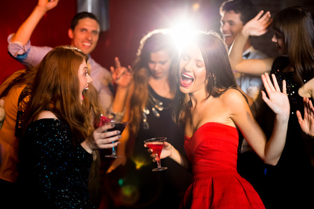 Happy friends having fun together at the nightclubの写真素材