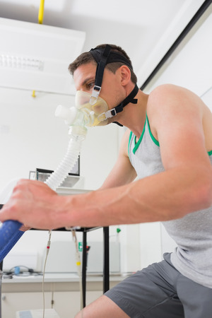 Man doing fitness test on exercise bike at the medical centreの写真素材