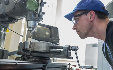 Engineering student using large drill at the universityの写真素材