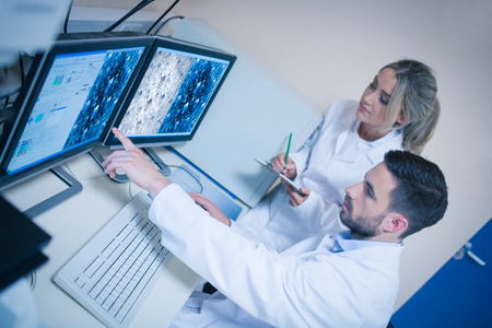 Science students looking at microscopic images at the university