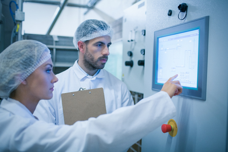 Food technicians working together in a food processing plantの写真素材