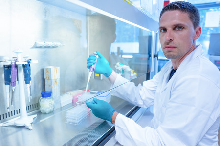 Science student using pipette in the lab at the university