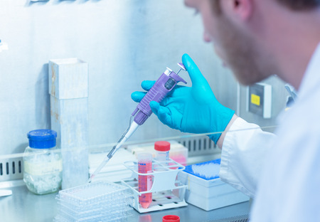 Science student using pipette in the lab at the university
