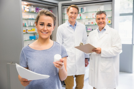Happy customer holding her medicine at the hospital pharmacyの写真素材