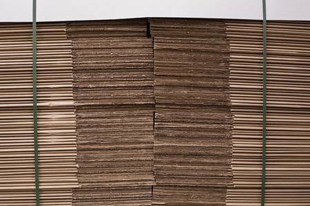 Close up of a stack of cardboard in a large warehouseの写真素材