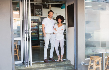 Portrait of colleagues smiling and posing together at the bakeryの写真素材