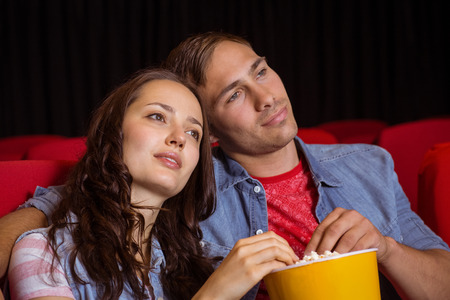 Young couple watching a film at the cinemaの写真素材