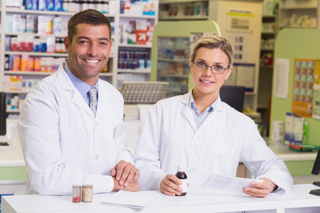 Pharmacists holding a prescription and medicines at the hospital pharmacyの写真素材