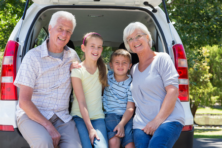 Grandparents going on road trip with grandchildren on a sunny dayの写真素材