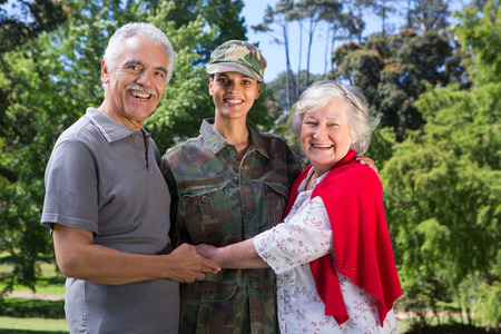 Soldier reunited with her parents on a sunny dayの写真素材