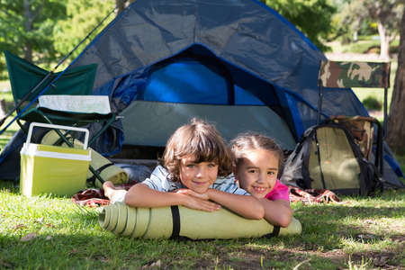 Happy siblings on a camping trip on a sunny dayの写真素材