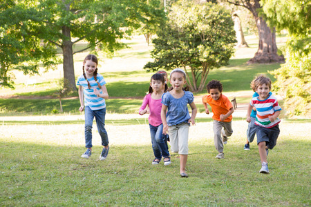 Children racing in the park on a sunny day Children racing in the park on a sunny day