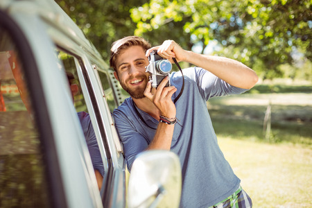 Handsome hipster taking a photo on a summers dayの写真素材