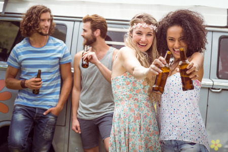 Pretty hipsters smiling at camera on a summers dayの写真素材