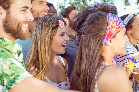 Happy hipsters listening to live music at a music festivalの写真素材