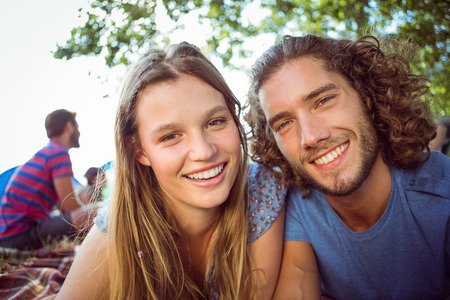 Hipster couple smiling at camera at a music festivalの写真素材