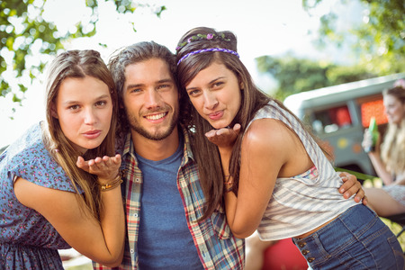 Handsome hipster is a hit with the ladies at a music festivalの写真素材