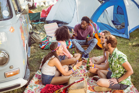 Hipsters having fun in their campsite at a music festivalの写真素材