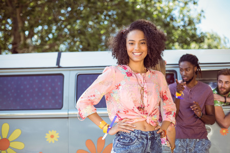 Pretty hipster smiling at camera at a music festivalの写真素材