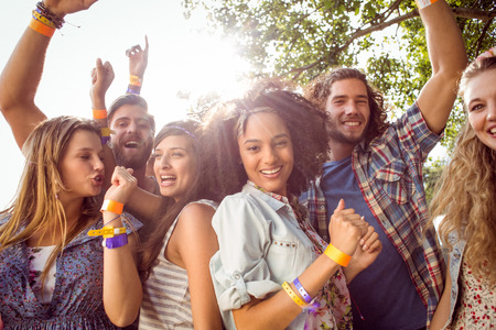 Happy hipsters dancing to the music at a music festivalの写真素材