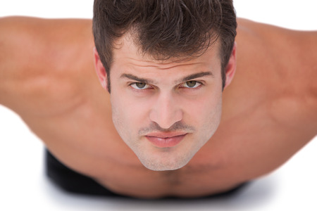 Fit shirtless man doing push ups on white backgroundの写真素材