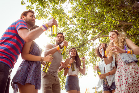 Happy hipsters dancing to the music at a music festivalの写真素材