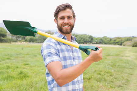 Happy man with his shovel on a sunny dayの写真素材