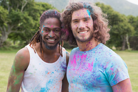 Friends having fun with powder paint on a sunny day