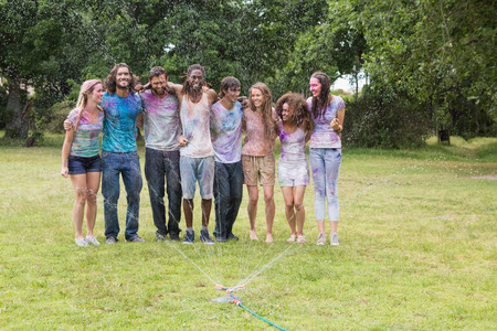 Young friends having fun with powder paint on a sunny dayの写真素材