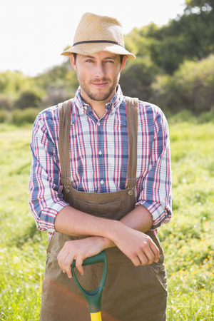 Happy farmer smiling at camera on a sunny dayの写真素材