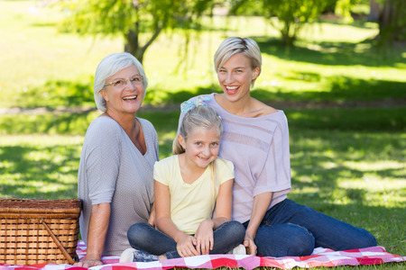 Happy blonde with her daughter and mother on a sunny dayの写真素材