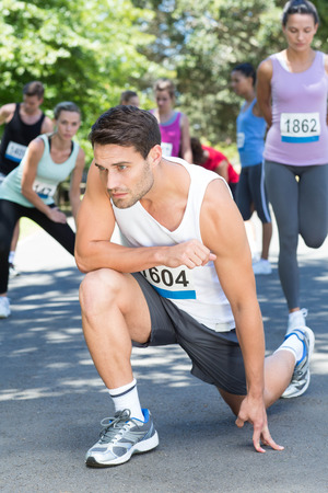 Fit man warming up before race on a sunny dayの写真素材