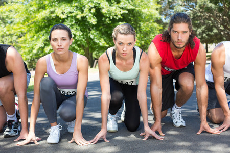 Fit people running race in park on a sunny day