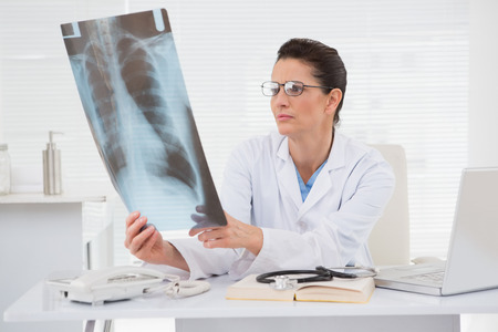 Doctor looking at scans in medical office