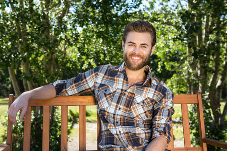 Handsome hipster relaxing in the park on a summers dayの写真素材