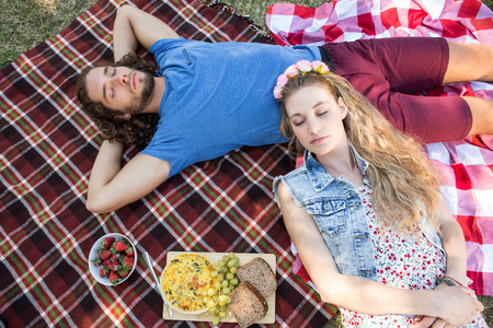 Cute couple having a picnic on a summers dayの写真素材
