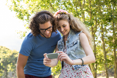 Cute couple looking at their selfie on a summers dayの写真素材