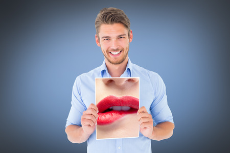 Close up of woman biting red lips against grey vignetteの写真素材