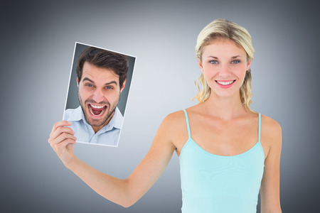 Cheering man looking at camera against grey vignette