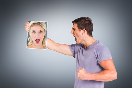 Shocked blonde holding a sheet of paper against grey vignette