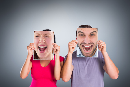 Cheering man looking at camera against grey vignette