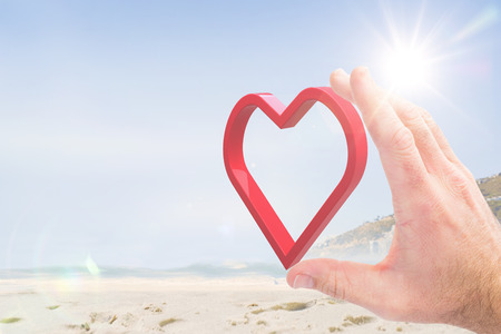 Hand presenting against beautiful beach and blue sky