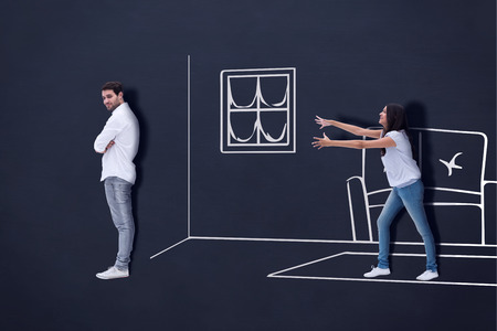 Brunette reaching desperately for man against blackboard