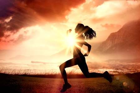 Full length of healthy woman jogging  against sunrise over magical sea