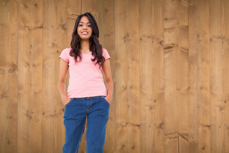 Pretty brunette stepping against wooden planksの写真素材