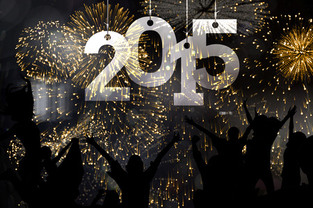 Silhouette of cheering people against colourful fireworks exploding on black background